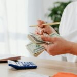 A woman counting her money to see how much she saved