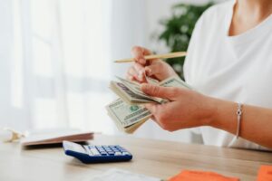 A woman counting her money to see how much she saved